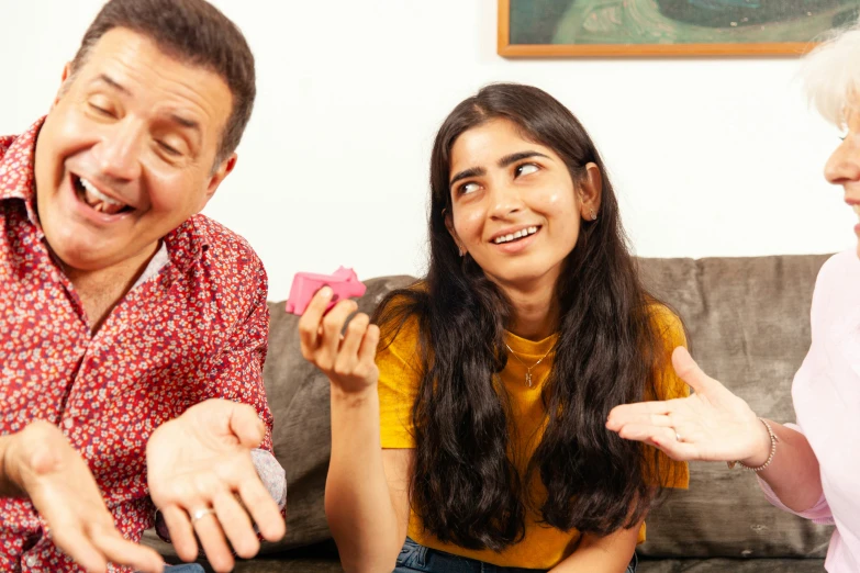 three older adults on a sofa laughing and laughing