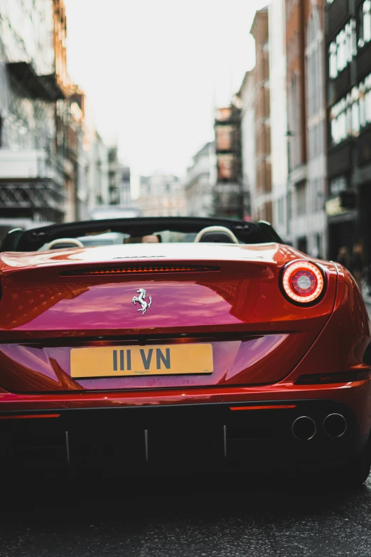 red sports car parked on street in urban setting