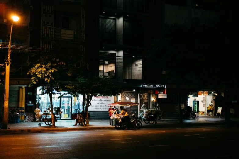 some motorcycles parked by a street with buildings in the background