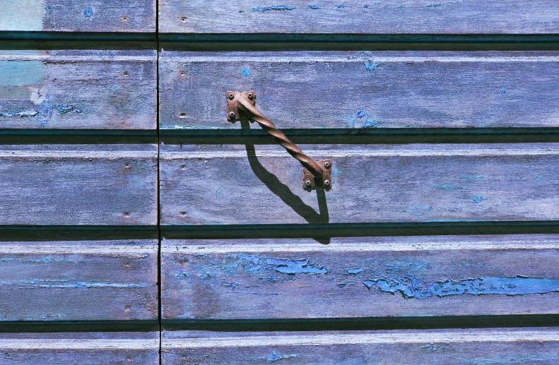 two hands are holding a rusty bar on the steps