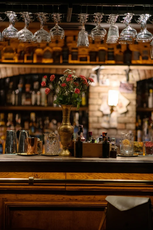 the bar has different kinds of glasses and bottles on it