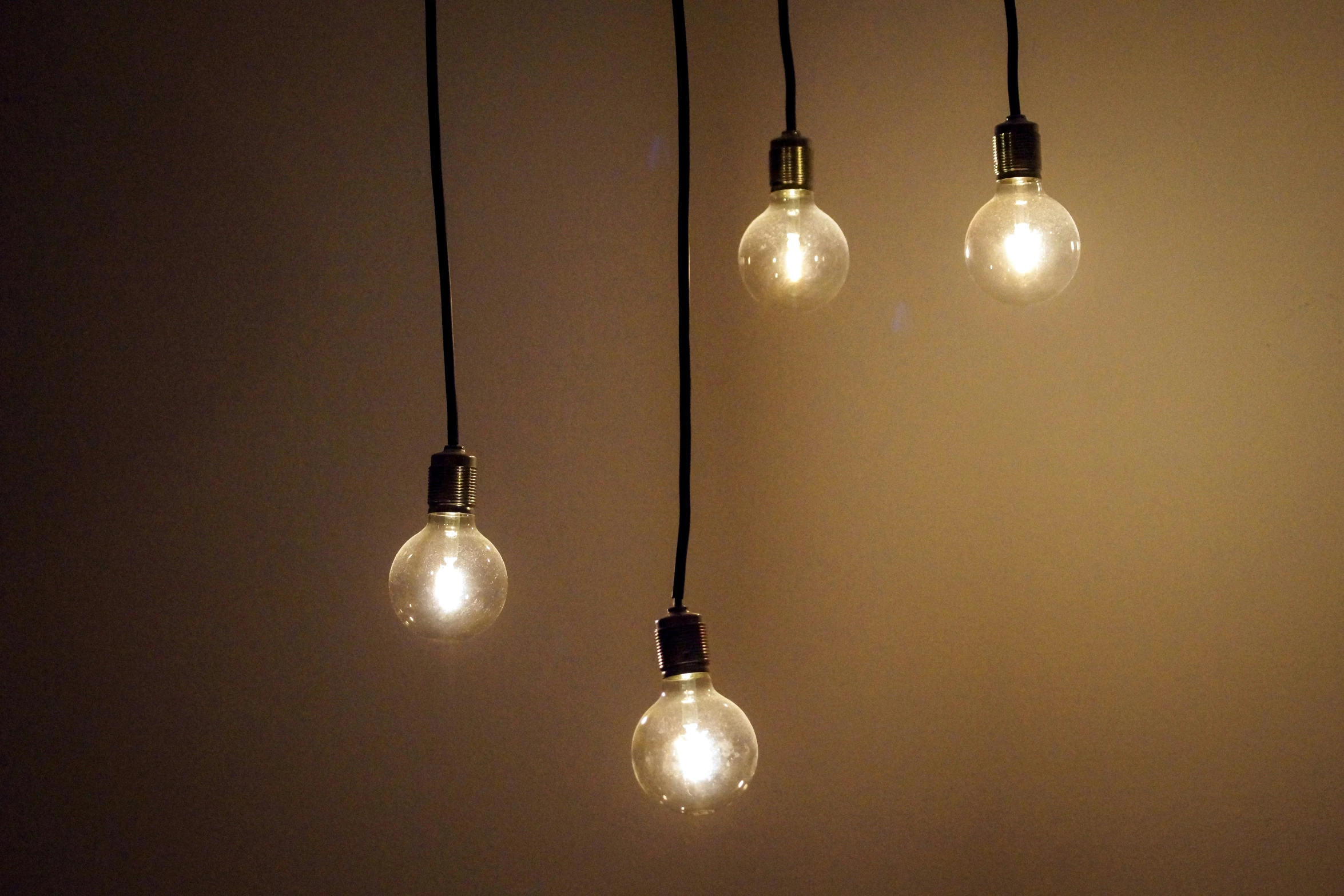 five bulb bulbs hung from a ceiling in the dark