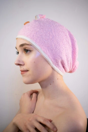 a woman with pink hair and a towel on her head