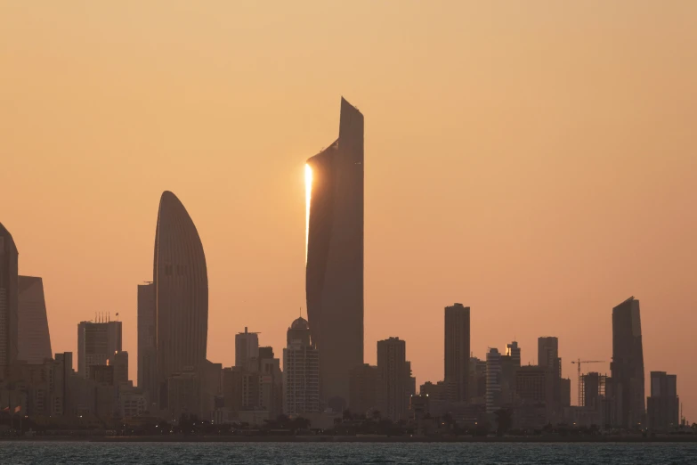 two tall buildings in the middle of a city skyline