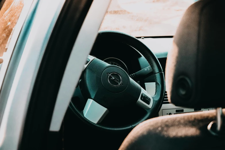 the interior of a car with wood steering wheel