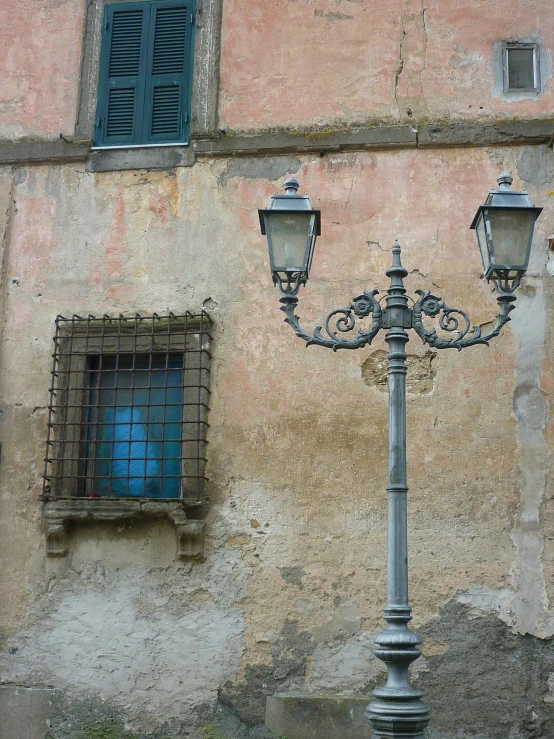street lamp on side of wall next to windows