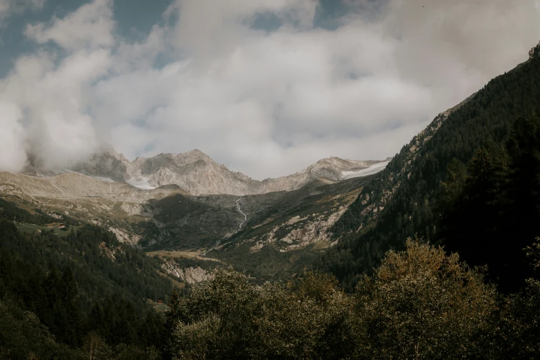 some mountains are covered in green and gray