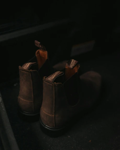 some brown shoes sitting on a black surface