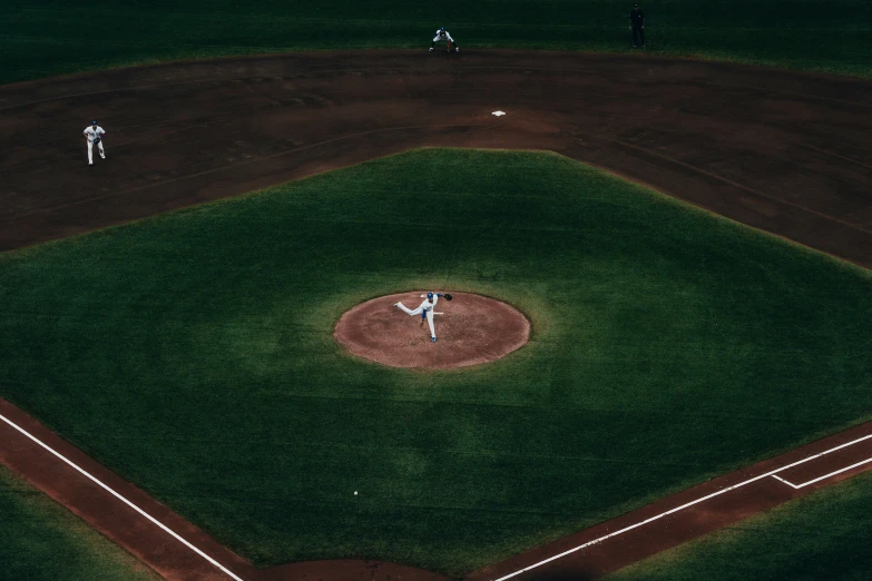 a pitcher throwing the baseball from the mound during a game