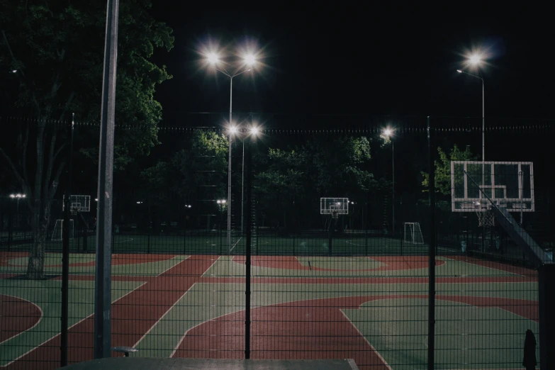 some lights that are sitting above a dirt field