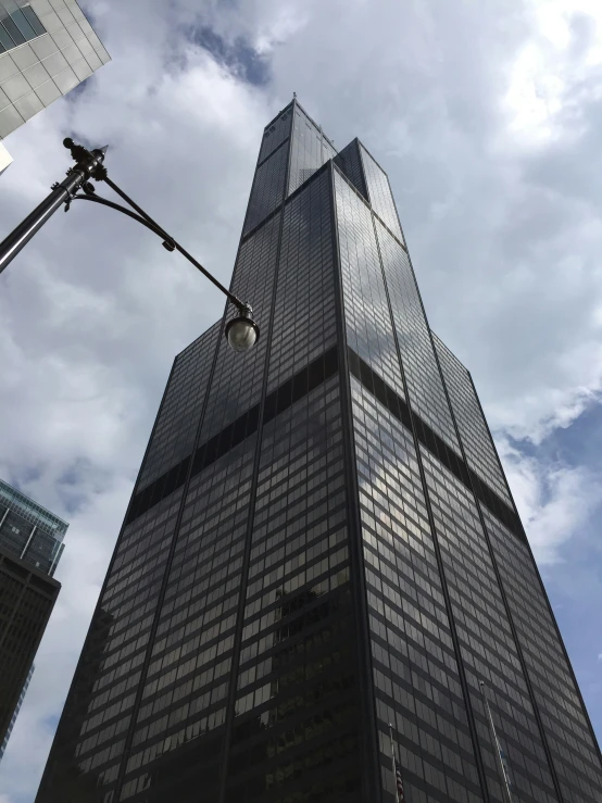 a tall glass building towering high up in the sky