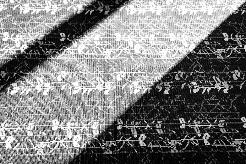 some letters written on fabric with black and white lines