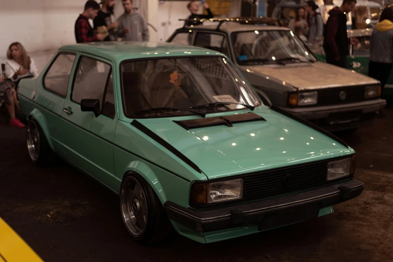 this is a green compact in a parking garage