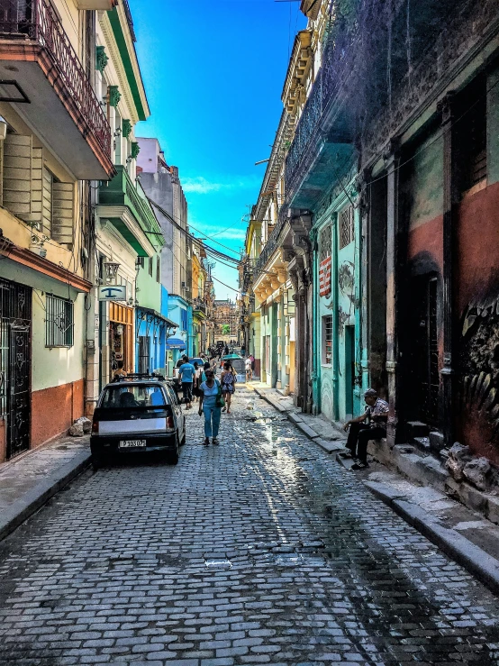 a car and people walking down a street