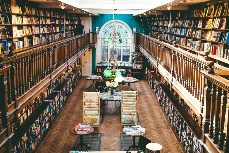 a liry filled with lots of books and a large window