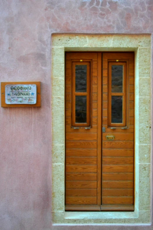 the two wooden doors have matching windows