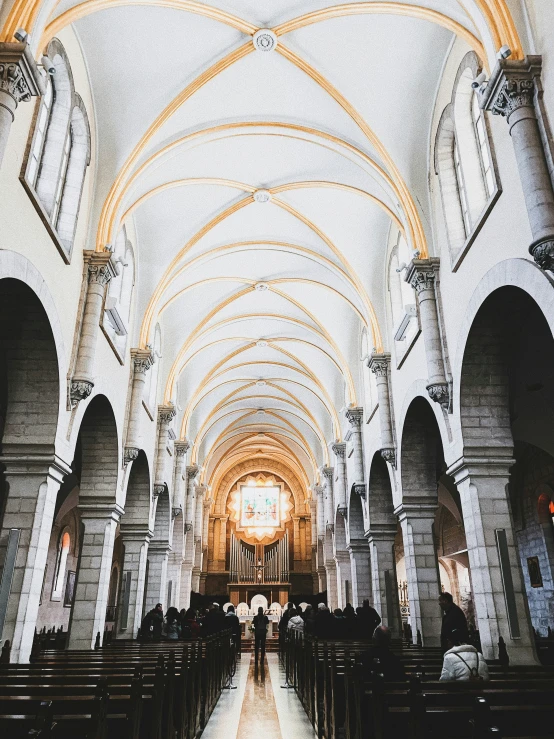 an indoor church with a beautiful, high ceiling and lots of pews