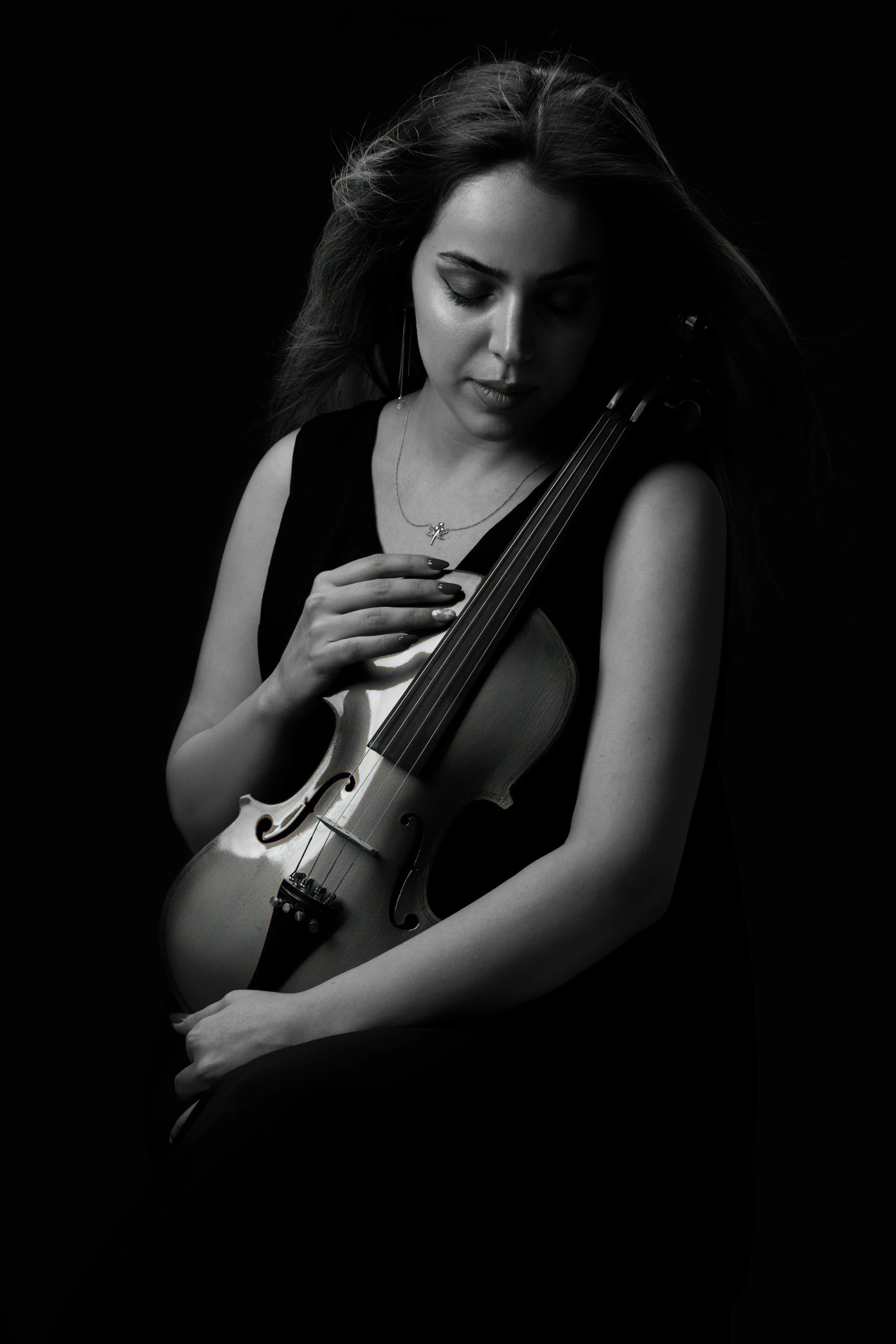 black and white pograph of a woman playing the violin