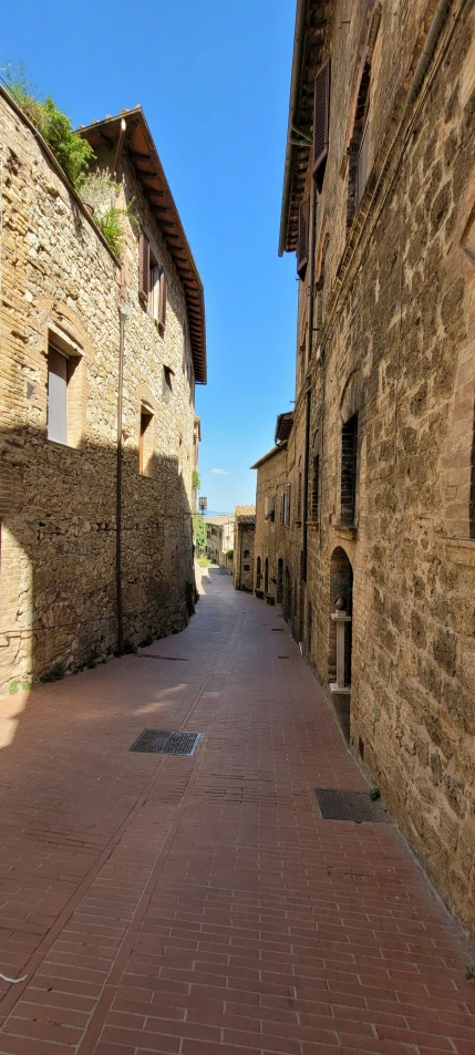 a brick street that runs between two buildings