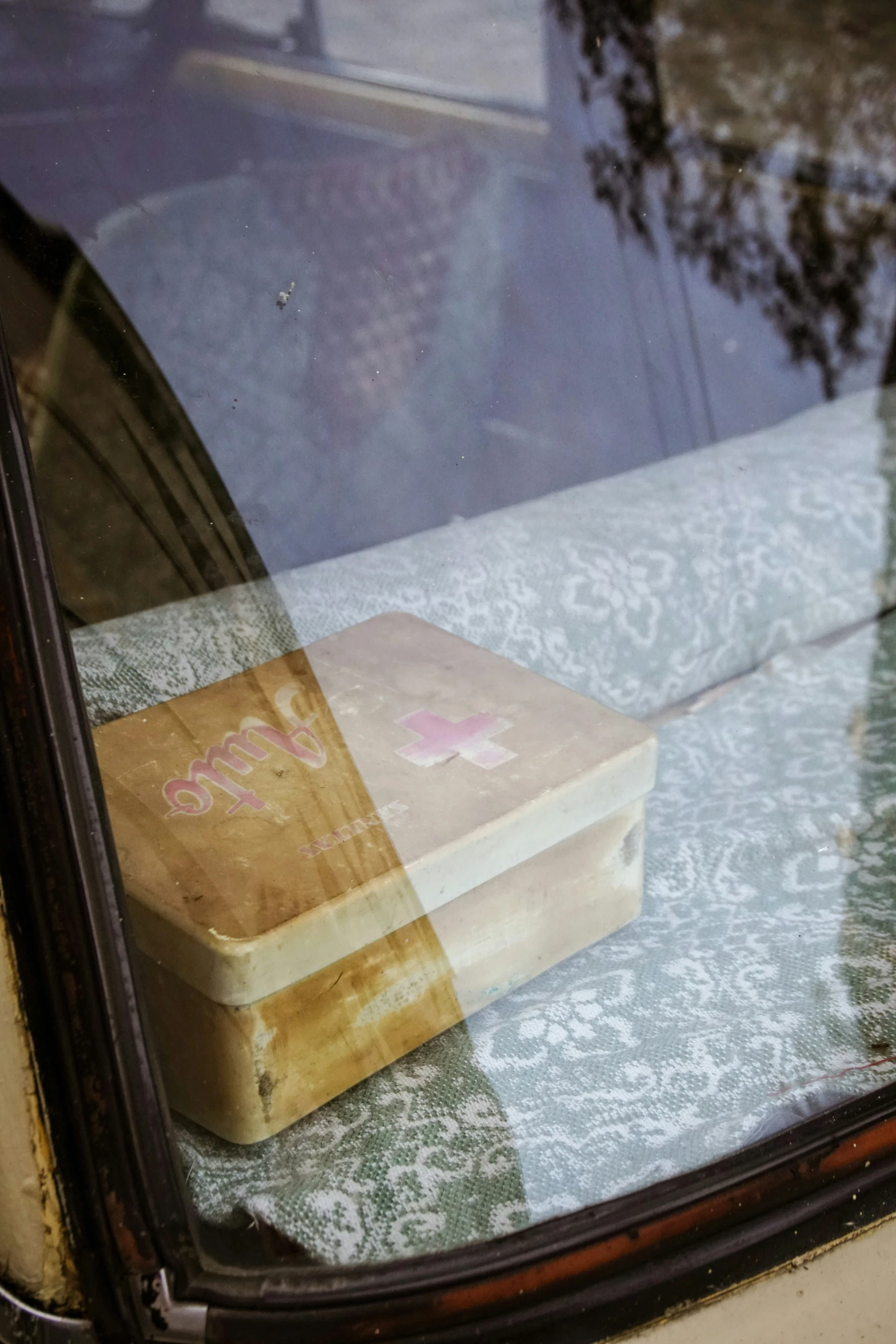 an old piece of luggage in the back window of a car