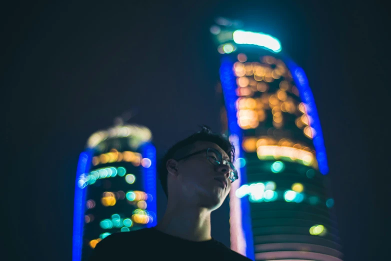 a man standing in front of some very colorful lights