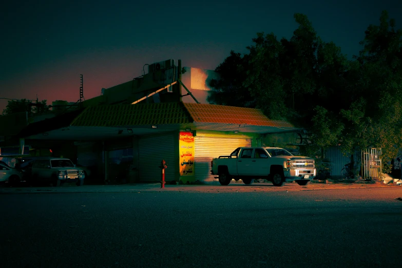 there are cars parked near a house with a tower