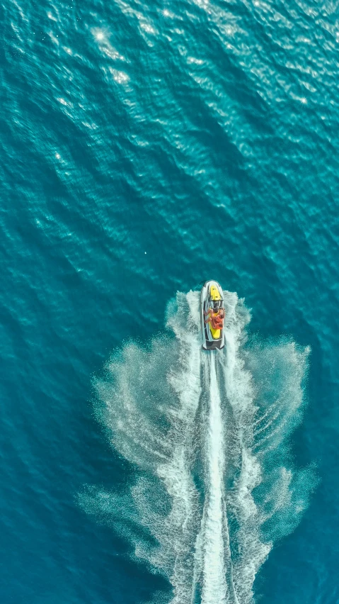 the top view of a motorboat moving across the water