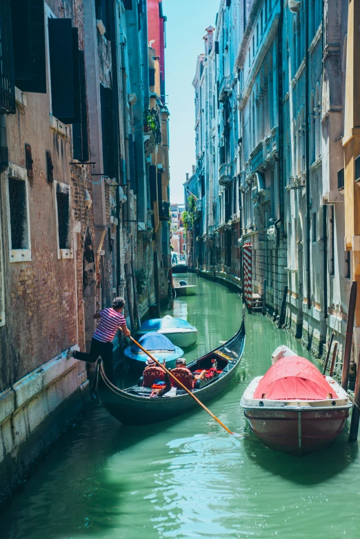 gondolas on a city canal with old buildings