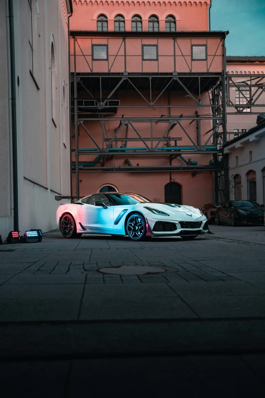 an acurace sitting in front of a building with scaffolding