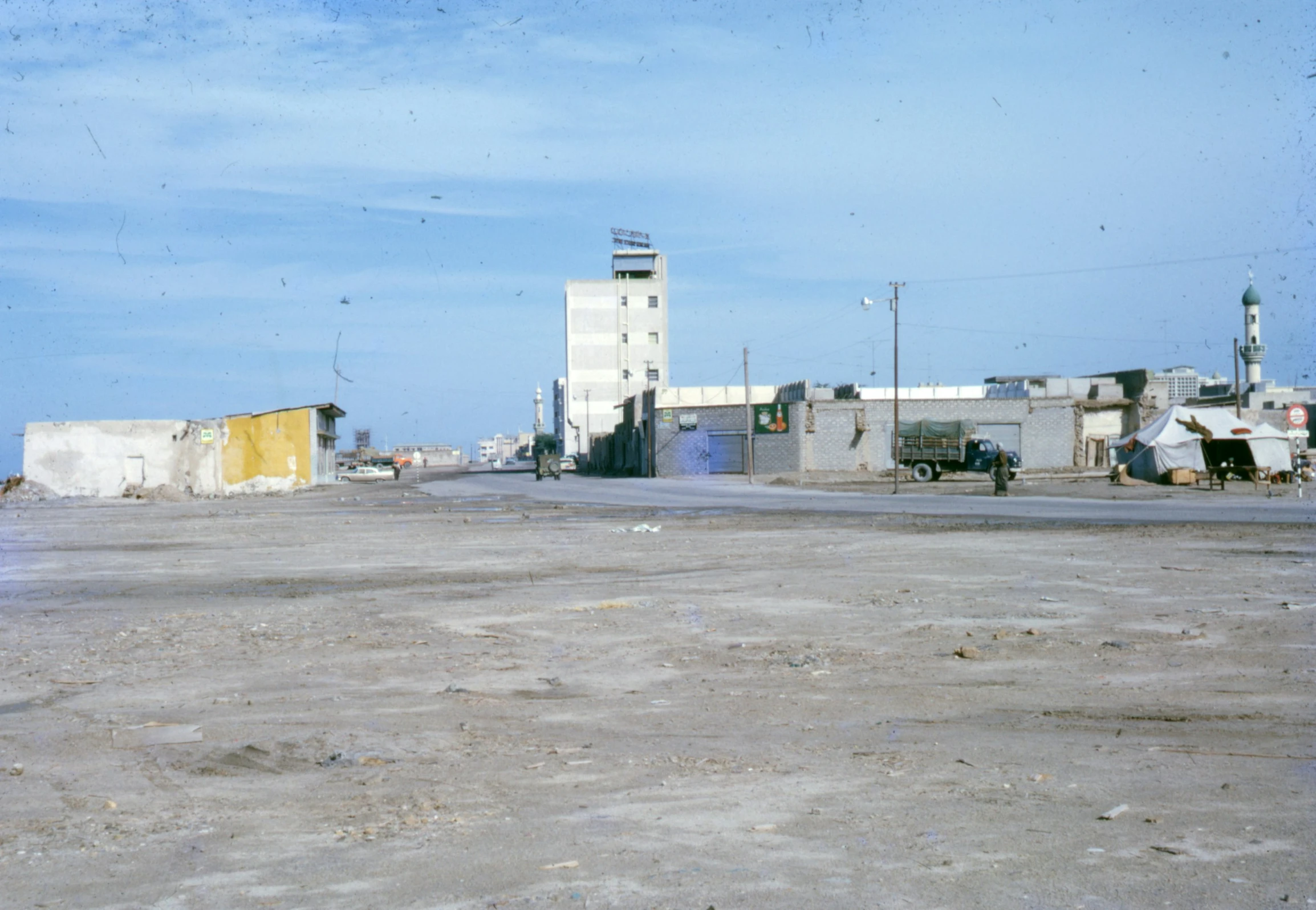 several old buildings on either side of an empty street