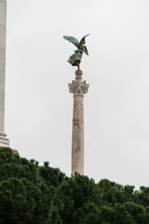 an image of a bird statue atop a monument