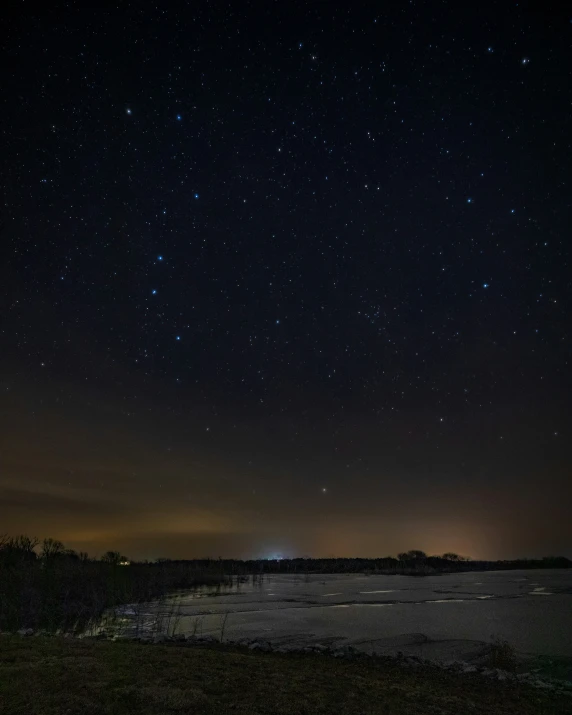 a night view of a field and the stars above