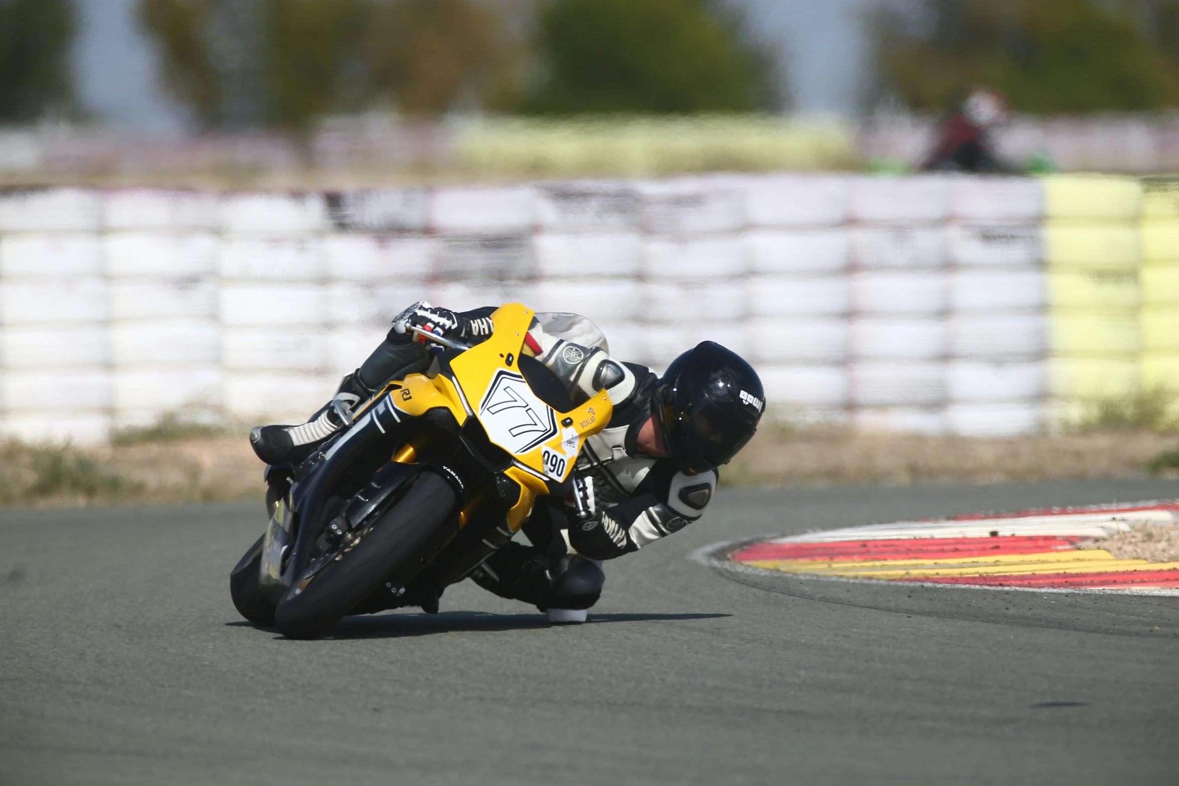 motorcycle racer on race track taking a sharp turn