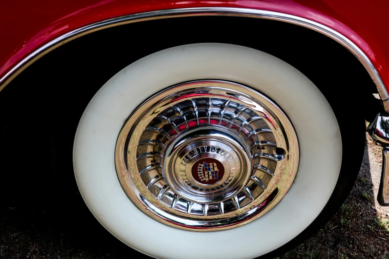 a close up view of the spokes and wheel on an old car