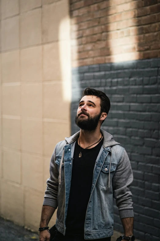 a young man with a beard is walking on the street