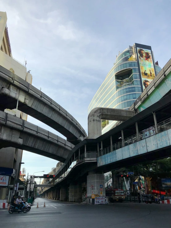 an elevated road next to a high rise building