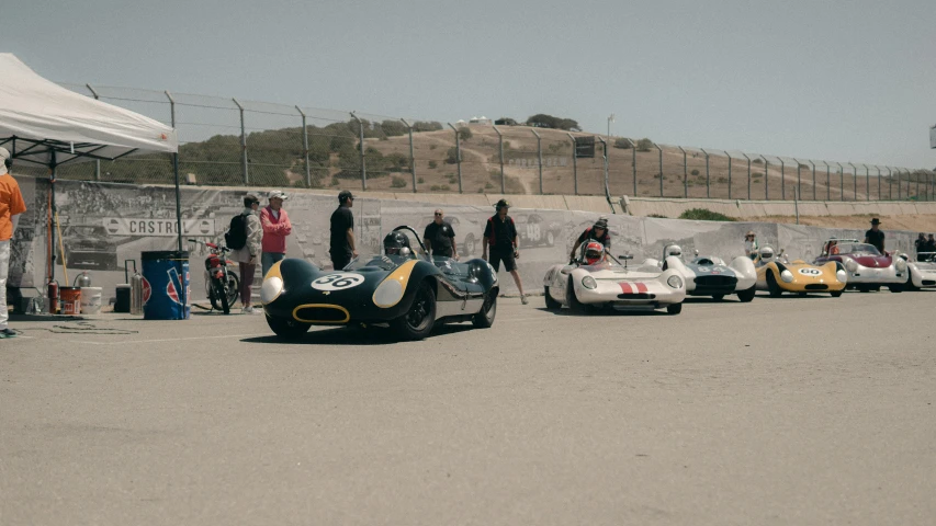 a few race cars are on a dirt track