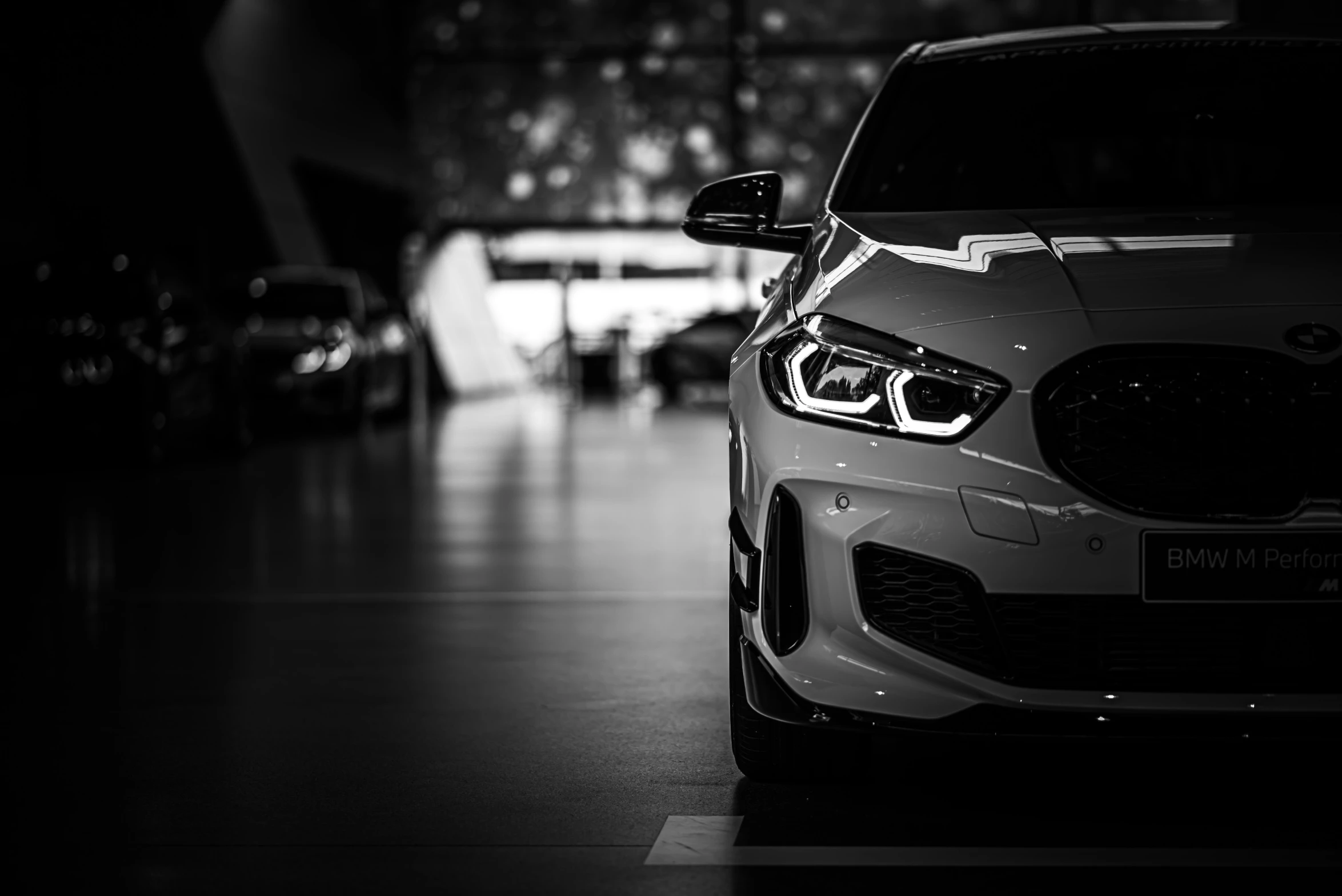 a car parked inside of a garage covered in cars