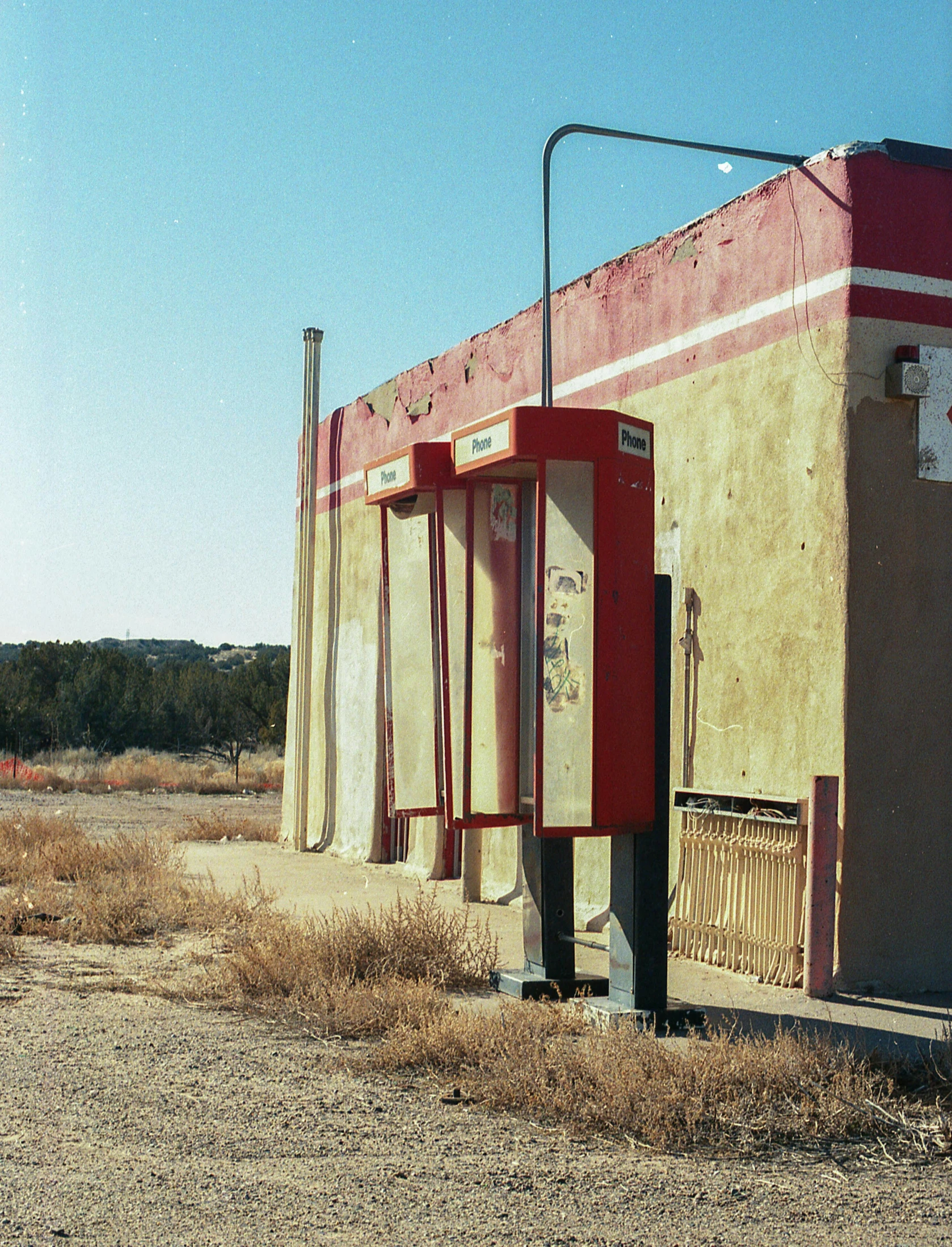 old fashioned telephone booths in an out - door area