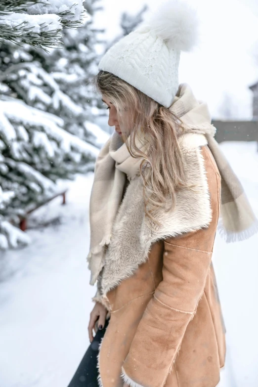 woman walking on a snowy path in winter clothing