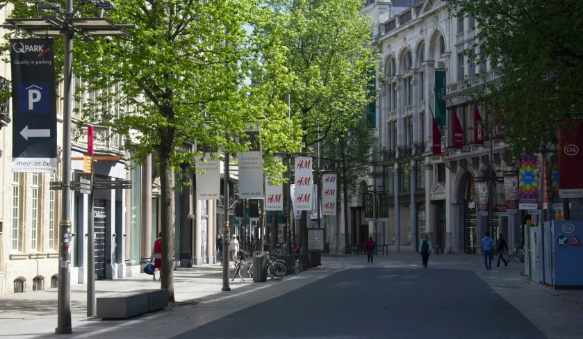 people are walking down the street in the city