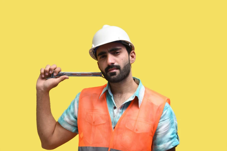 a male in a vest and a hard hat