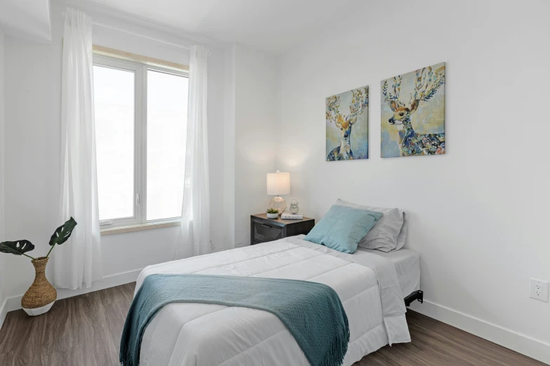 a clean bedroom is decorated with white walls