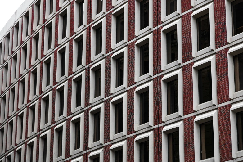 a tall building with lots of windows and red bricks