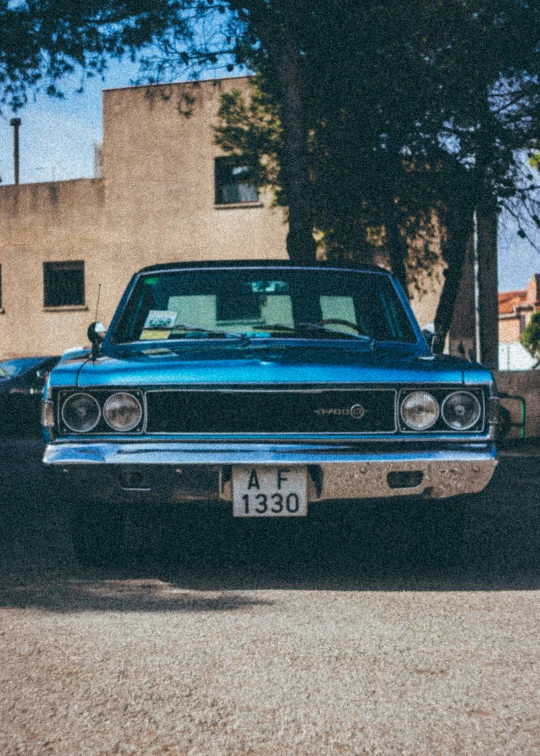 this car is parked in a street with cars behind it