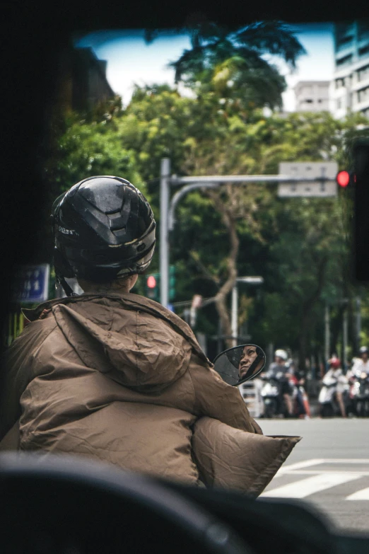 a man riding down a city street with a helmet on