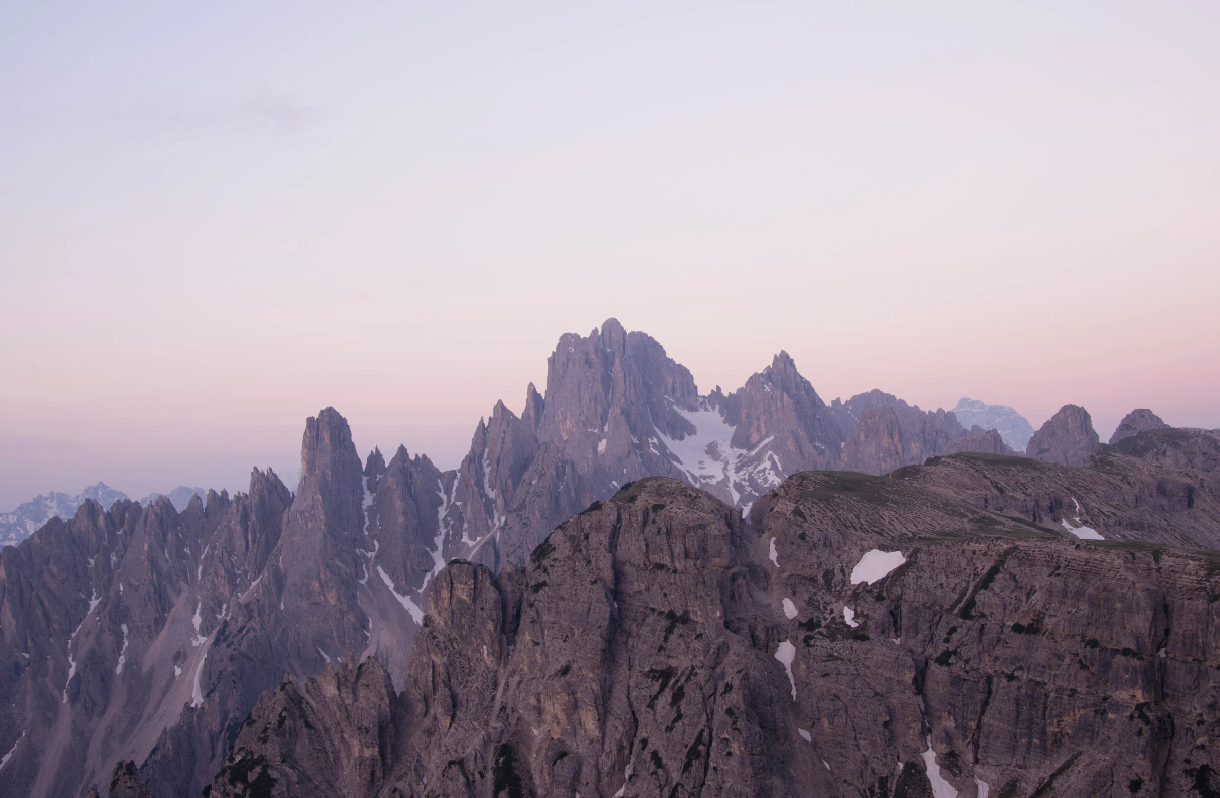 the mountains are covered in snow and mountain tops