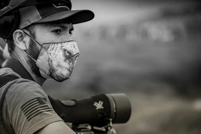 a man wearing a mask and holding up a baseball bat