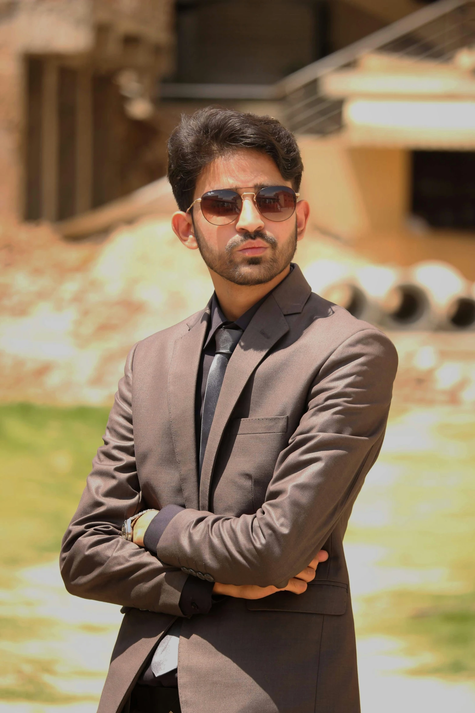 a man wearing shades and suit posing for the camera