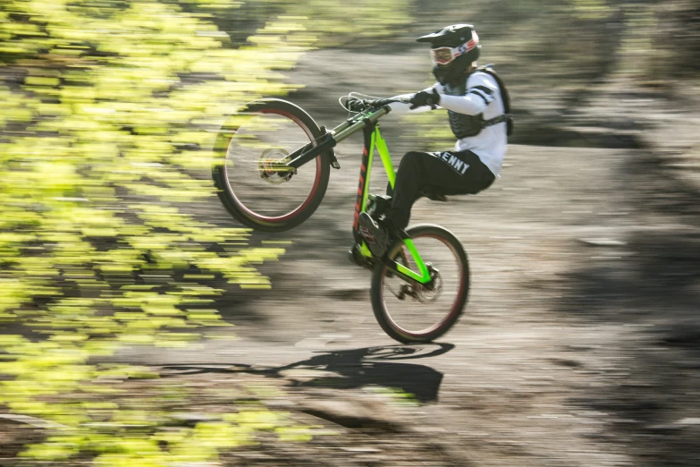 a downhill biker riding his bike down a trail